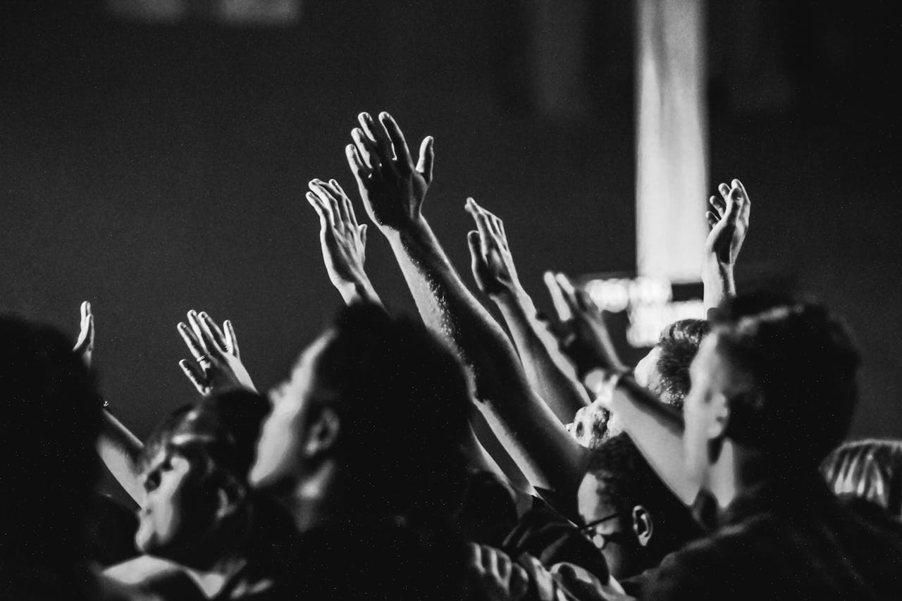 A group of people with their hands raised to God