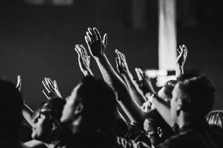 A group of people with their hands raised to God