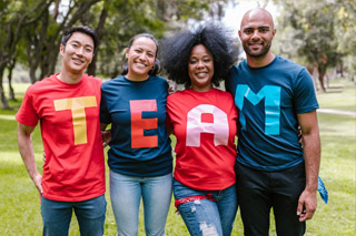 A group of people wearing shirts that spell team